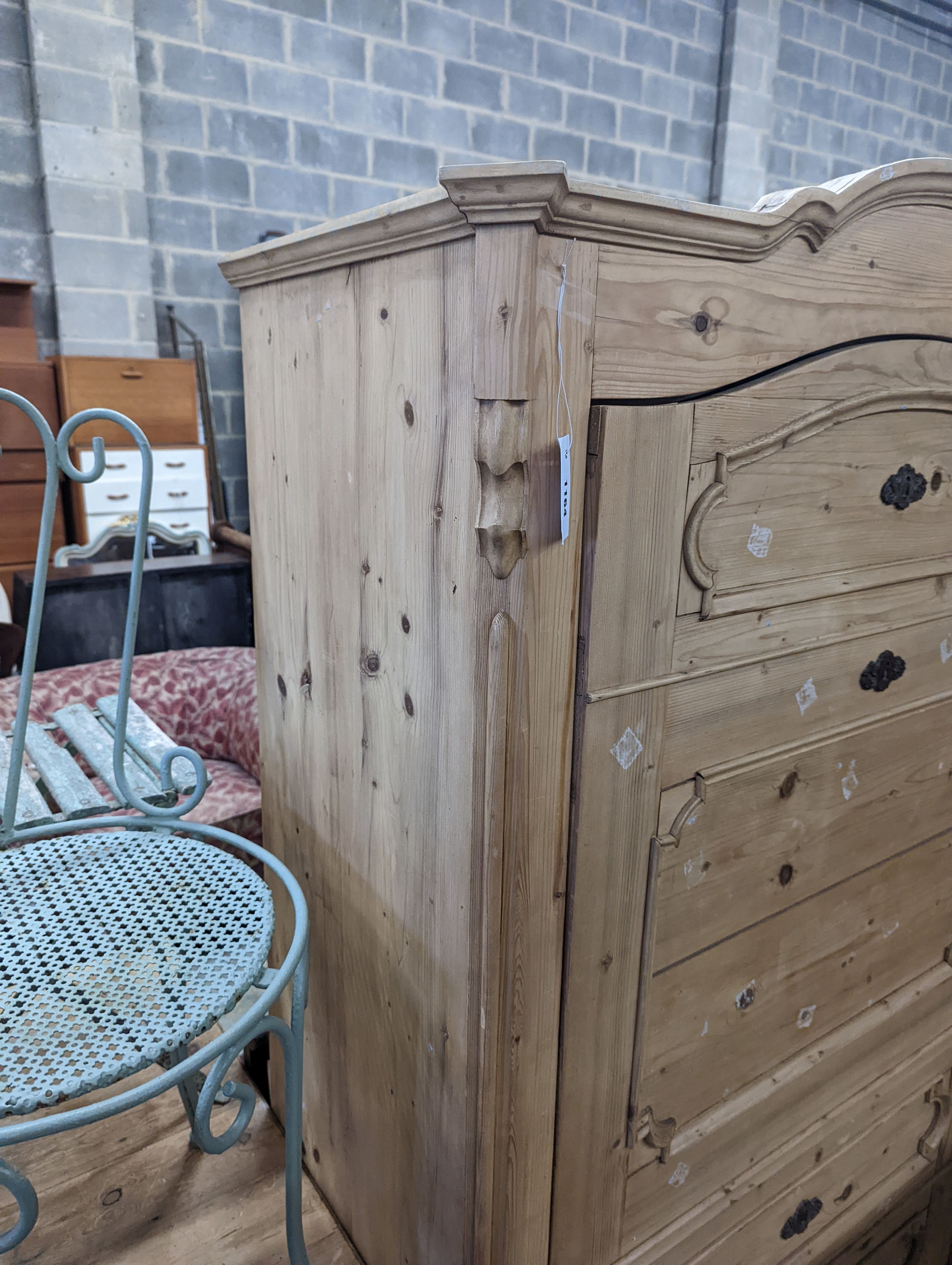 A 19th century Continental pale pine hanging cupboard with dummy drawer front, width 104cm, depth 50cm, height 183cm